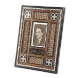 A SYRIAN SANDALWOOD PICTURE FRAME 20TH CENTURY with Mashrabiya panels and marquetry decoration in