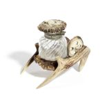 A VICTORIAN DEER ANTLER INKWELL LATE 19TH CENTURY in the form of a wheelbarrow, with a single