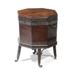 A GEORGE III MAHOGANY OCTAGONAL WINE COOLER C.1790 brass bound and with a lead lined interior,