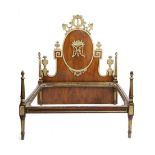 A FRENCH EMPIRE WALNUT AND PARCEL GILT BED HEADBOARD EARLY 19TH CENTURY with a scrolling bird and