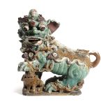 A CHINESE STONEWARE LION DOG 18TH / 19TH CENTURY facing left, in turquoise and ochre glazes 37cm