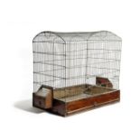 A BRASS WIREWORK BIRDCAGE EARLY 19TH CENTURY with a hinged door and mahogany base with two feeding