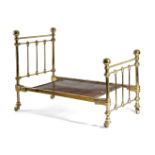 A BRASS DOLL'S BED FRAME IN VICTORIAN STYLE with railed head and foot boards, with orb finials and a