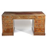 A MAHOGANY TWIN PEDESTAL DESK 19TH CENTURY the top inset with gilt tooled red leather, above an