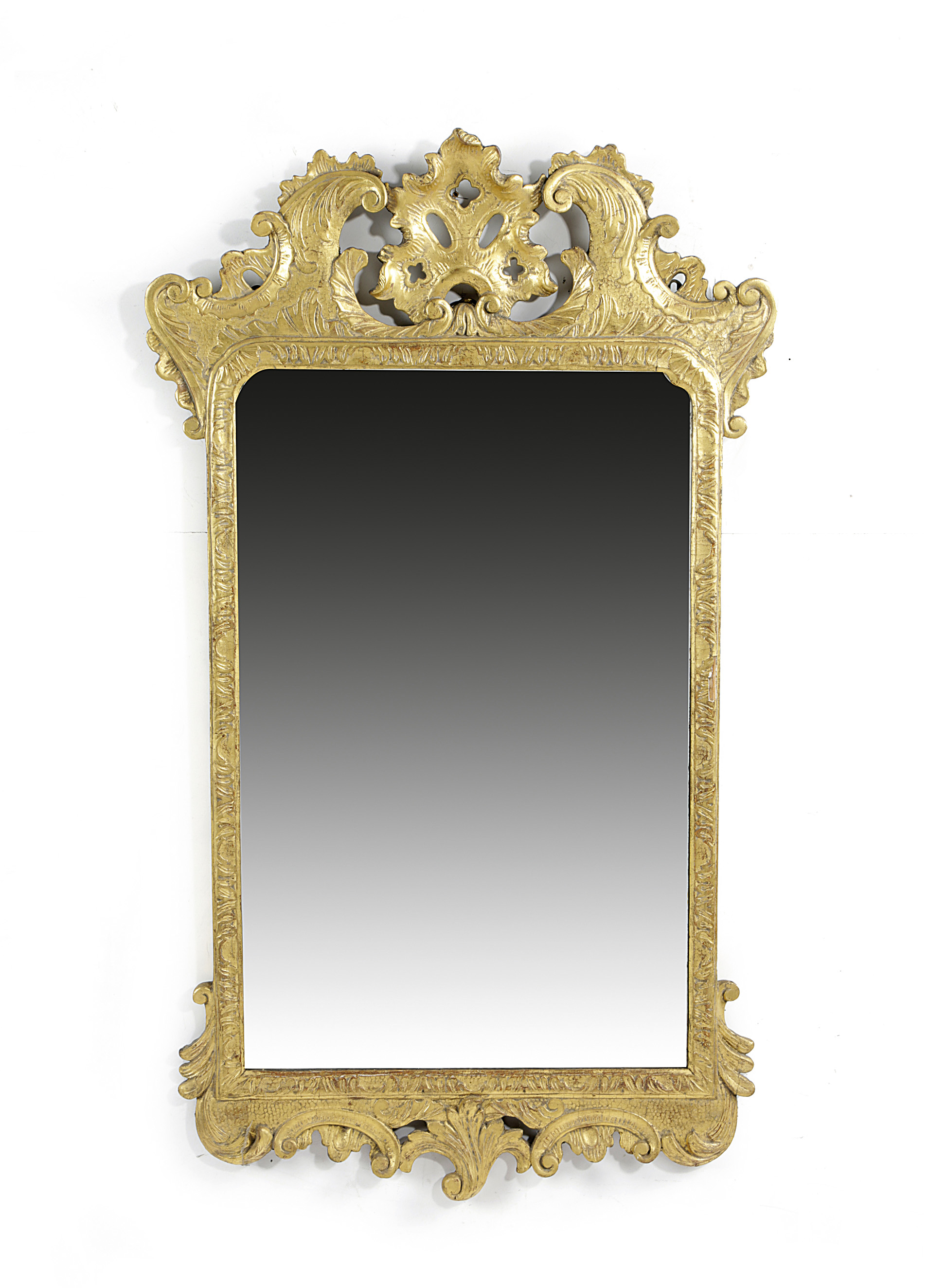 A GEORGE II GILTWOOD WALL MIRROR C.1735 the later arched bevelled plate within a leaf carved