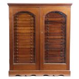 A VICTORIAN MAHOGANY COLLECTORS CABINET C.1870-80 with a pair of glazed arched doors enclosing