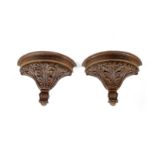 A PAIR OF CARVED OAK WALL BRACKETS / CORBELS decorated with leaves 49cm high, 65.6cm wide, 31.4cm