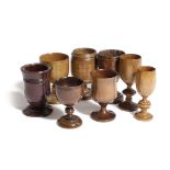 SEVEN TREEN GOBLETS 19TH CENTURY AND LATER in various woods including peach, apple, pine and