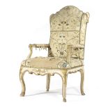 AN ITALIAN PAINTED AND PARCEL GILT ARMCHAIR 18TH CENTURY covered with distressed embroidered silk,