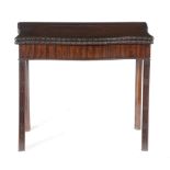 A GEORGE III SERPENTINE CARD TABLE C.1770 the fold-over top with a ribbon and floret carved edge, on