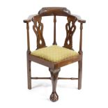 A MAHOGANY CHILD'S CORNER ARMCHAIR IN GEORGE II STYLE 19TH CENTURY with pierced splats above a