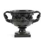 A CAST IRON WARWICK VASE GARDEN URN AFTER THE ANTIQUE, 19TH CENTURY painted black, with entwined