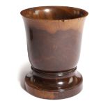 A TREEN LIGNUM VITAE MORTAR 18TH CENTURY with a flared rim above a short moulded stem and foot