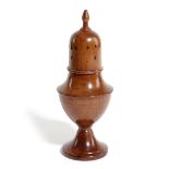 A TREEN FRUITWOOD CASTER OR MUFFINEER 19TH CENTURY of urn shape with a pierced detachable cover 19.