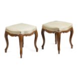 A PAIR OF VICTORIAN WALNUT STOOLS IN LOUIS XV STYLE C.1860-70 each with a later upholstered seat, on