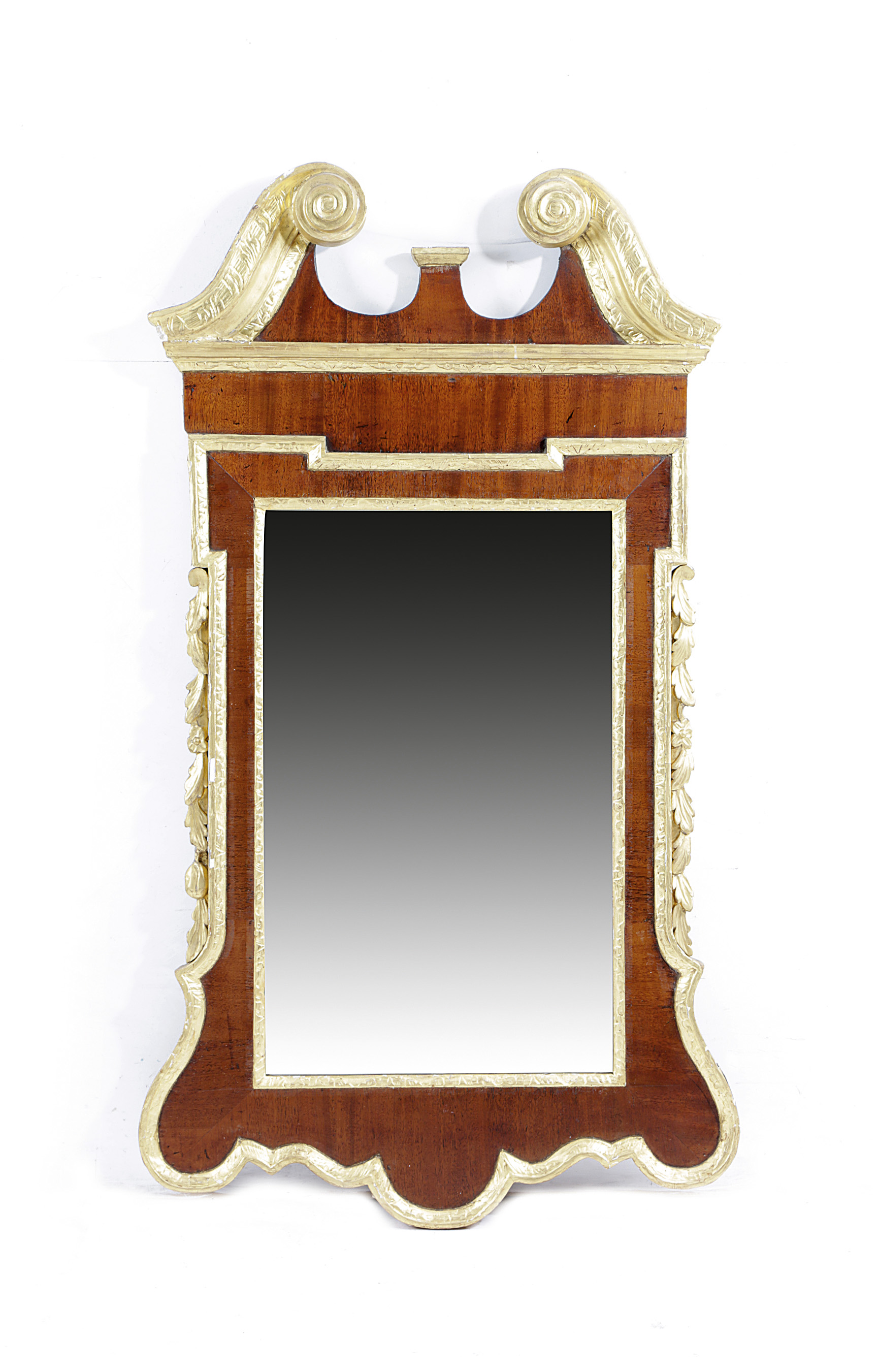 A GEORGE II MAHOGANY AND GILTWOOD WALL MIRROR C.1735-40 the later bevelled plate within a carved