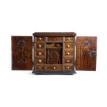 λ A NORTH ITALIAN CEDAR POKER AND PENWORK TABLE CABINET 17TH CENTURY AND LATER with a pair of doors,