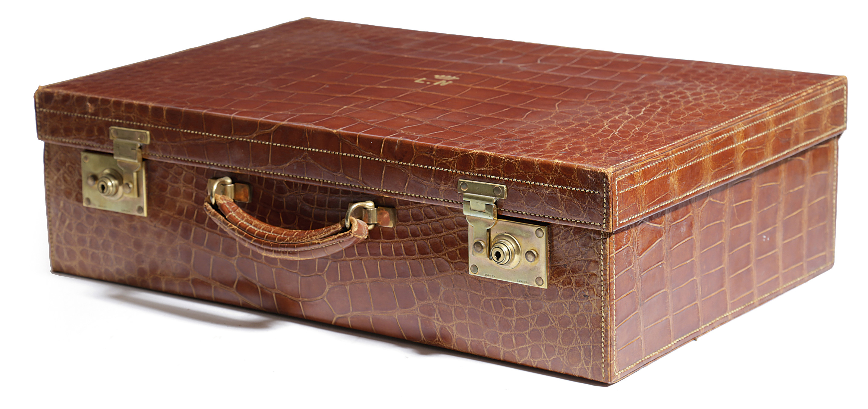 A GEORGE V ASPREYS CROCODILE SUITCASE C.1930 with brown watered silk lined interior, lacking inner