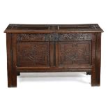 A CHARLES II OAK COFFER C.1680 the twin panelled top on pin hinges, with a till, the front with a