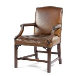 A LATE GEORGE III MAHOGANY AND LEATHER UPHOLSTERED ARMCHAIR EARLY 19TH CENTURY the slightly arched