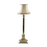A BRASS CORINTHIAN COLUMN STANDARD LAMP with an adjustable stem 137cm high, 39cm wide Provenance