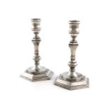 A pair of cast silver candlesticks, by R. Comyns, London 1956, in the George I manner, hexagonal