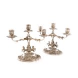 A pair of continental silver three-light candelabra, unmarked, central pierced foliate stems, with