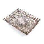 A metalware filigree dressing table tray, unmarked, rectangular form, with scroll and simulated coin