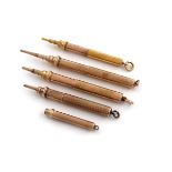 A collection of five gold and gilt-metal single extension propelling pencils, including: a 9 carat