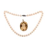 A citrine pendant and a cultured pearl, ruby and diamond necklace, the gold pendant set with a large