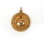 A gold zodiac pendant, circa 1952, the gold medallion depicting a crab and star for Cancer, the