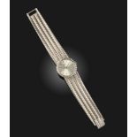 A lady's 18ct white gold and diamond wristwatch, Piaget, the circular silvered dial with baton