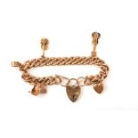 A gold charm bracelet, mid 20th century, the curb link bracelet suspending five charms, including