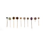 A group of ten stick pins, the finial designs comprising: a circular-cut citrine in a border of seed
