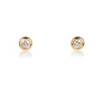 A pair of diamond stud earrings, each designed as a brilliant-cut diamond within a gold collet
