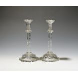 A pair of cut glass tapersticks c.1790, the slender faceted stems rising to flared sconces above