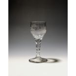 A small wine glass c.1770, the rounded bowl engraved with a continuous hunting scene, a figure on