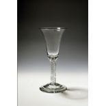 A large wine glass or goblet c.1750, the generous bell bowl rising from a multi series airtwist stem