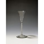 A toasting glass or wine glute c.1760-70, the slender drawn trumpet bowl rising from a tall opaque