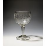 A large ceremonial goblet c.1750, the cup-shaped bowl engraved with a band of fruiting grapevine