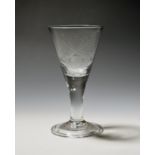 A Dutch engraved wine glass c.1740-50, the wide drawn trumpet bowl engraved with crossed cannon
