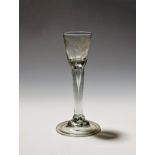 An Irish cordial glass of Jacobite significance c.1740-50, the small rounded funnel bowl engraved