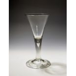 A large toasting glass or goblet c.1750, the generous drawn trumpet bowl rising from a thick plain