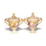 A pair of Swansea-style two-handled cups and covers c.1810-30, each painted with a wide band of