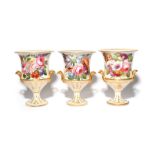 A garniture of three Coalport vases c.1800-20, of campana form, boldly decorated, possibly in a