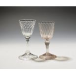 Two façon de Venise wine glasses early 18th century, one of a pinkish hue, the bucket bowl with