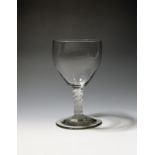 A large glass goblet c.1765, the generous bowl of slight ogee form and raised on a double series