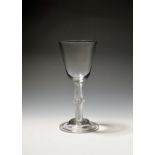 A large wine glass c.1750, the rounded funnel bowl raised on a dense airtwist stem with central