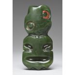 A Maori hei-tiki pendant New Zealand nephrite, with a tilted head with red sealing wax to the left