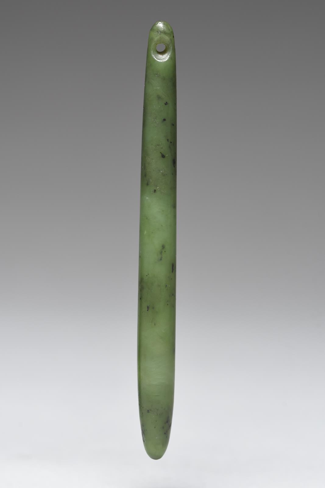 A Maori ear pendant New Zealand nephrite, with a pierced suspension hole to the top, 12.2cm long.